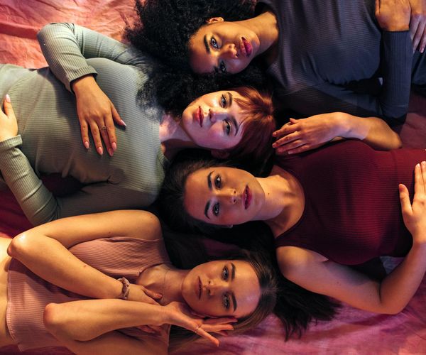 Diverse group of people meditating together peacefully.